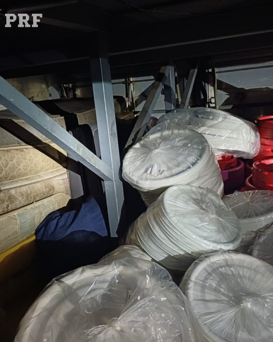 Banheiro obstruído por mercadorias e interior do ônibus em condições degradantes durante fiscalização na BR-153 