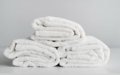 Família com toalhas organizadas por tipo e função: planejamento evita desperdício e garante uniformidade no banheiro (